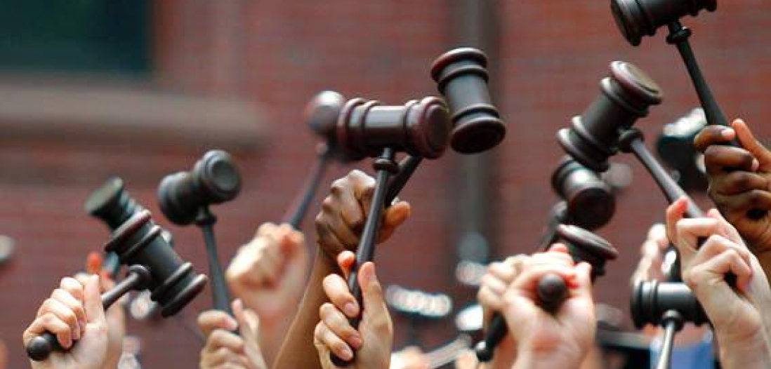 A group of people holding their gavels into the air