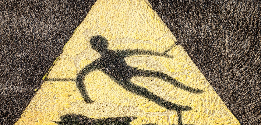 A floor sign depicting a person slipping over
