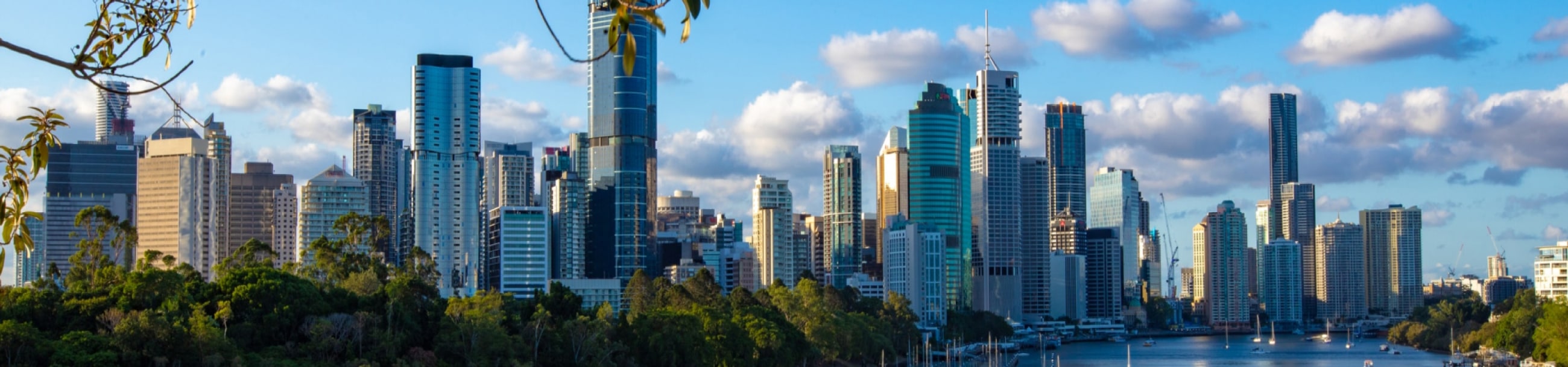 A cityscape photo overlooking the Brisbane River on a sunny afternoon